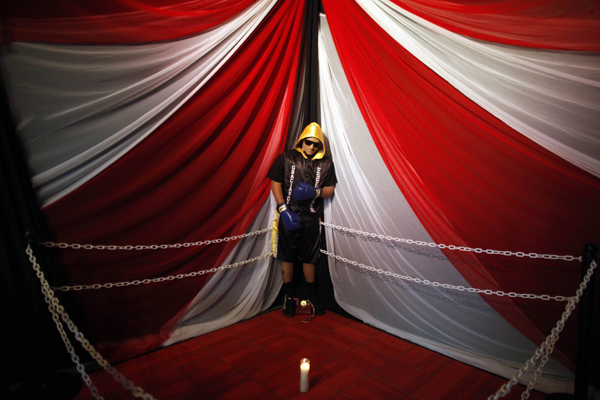 The body of boxer Christopher Rivera, who was shot to death on Sunday, is propped up in a fake boxing ring during his wake at the community recreation center within the public housing project where he lived in San Juan, Puerto Rico, Jan. 31, 2014.